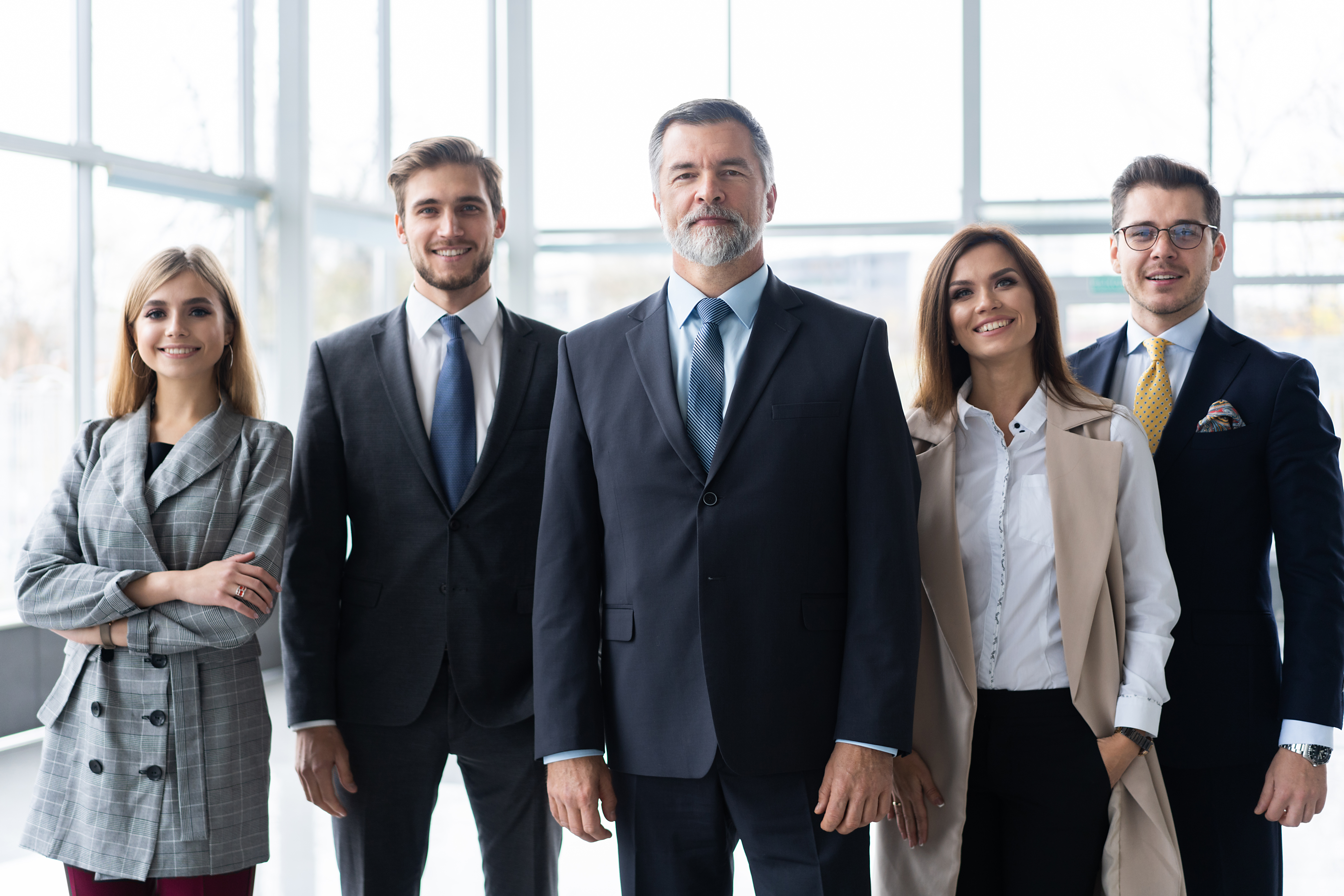 Happy business team with arms crossed at the office.